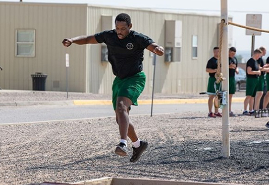 McCray running through one of the obstacles as part of the training program for the Border Patrol Academy